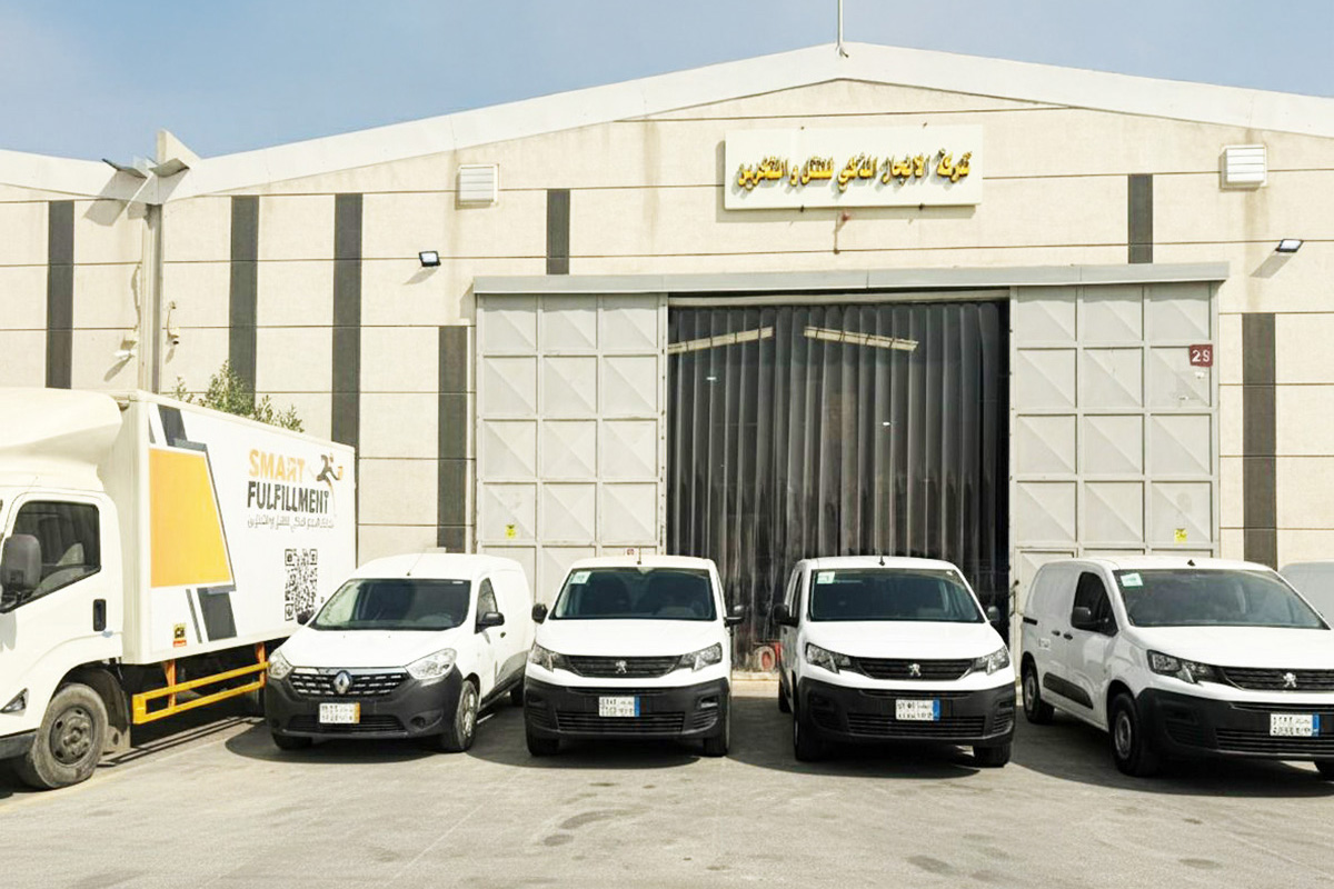 Smart Fulfillments facility exterior with delivery fleet